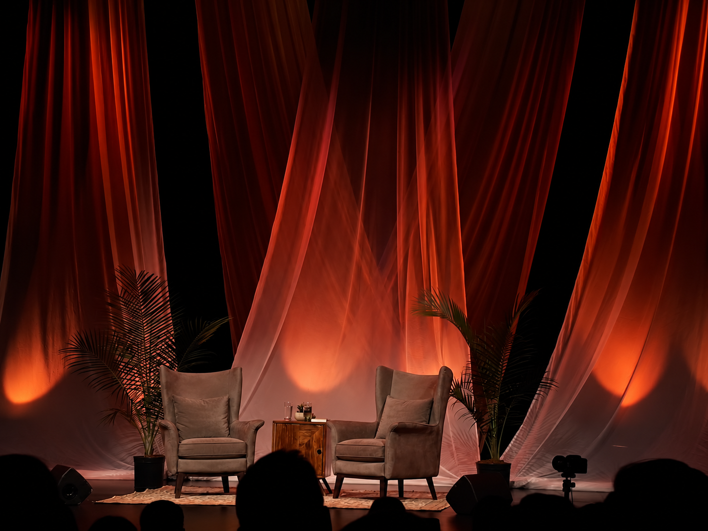 Seven chairs set on stage for The Seven Chairs conversation